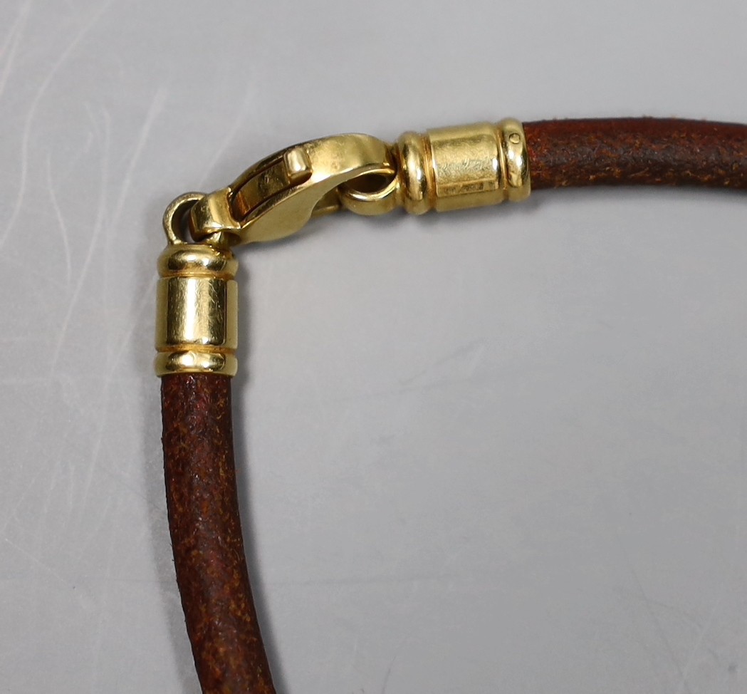 A modern Bulgari 18k and steel circular 'sun' pendant, 30mm, on a Bulgari fabric necklet, with 750 clasp, gross weight 27.4 grams.